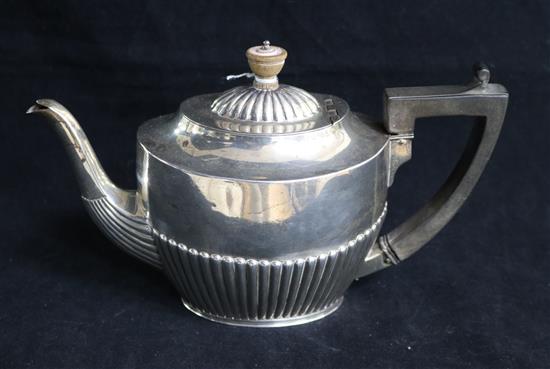 A late Victorian demi fluted silver oval teapot by Army & Navy, London, 1888, gross 16 oz.